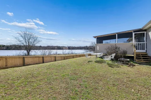 a swimming pool with outdoor seating and yard