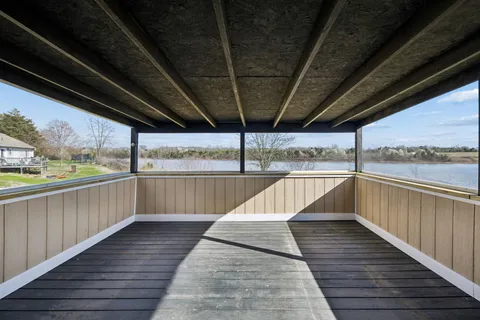 a view of balcony with wooden floor