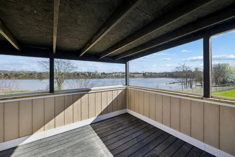 a view of a balcony with wooden floor
