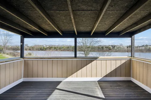 a view of balcony with wooden floor