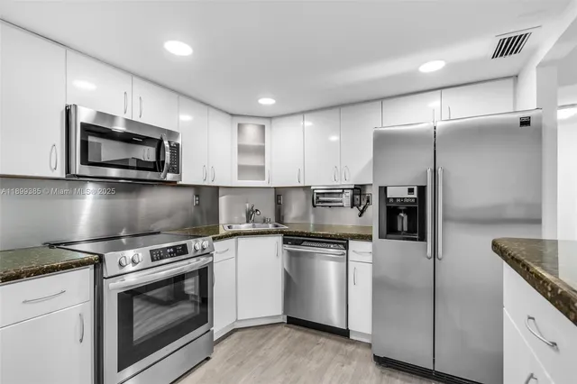 a kitchen with a sink microwave and refrigerator