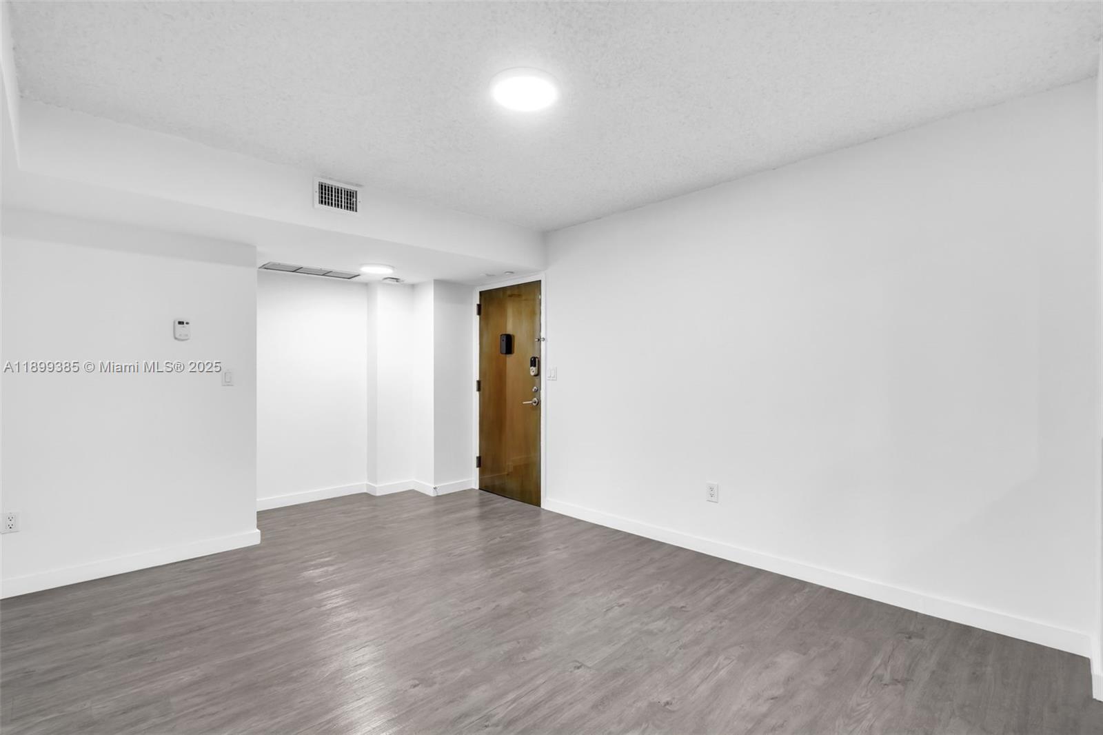 2333 Brickell Avenue, Unit PH208 Miami, FL 33129 - Photo 9 of 40 a view of an empty room with wooden floor