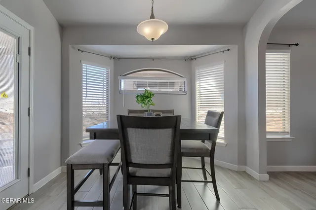 a dining room with furniture and window