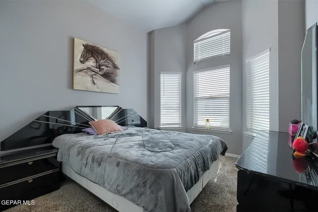 a bedroom with bed and window