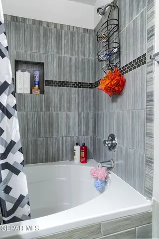 a bathroom with a bathtub and shower