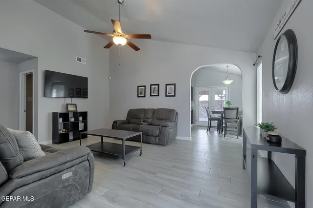 a living room with furniture and a flat screen tv
