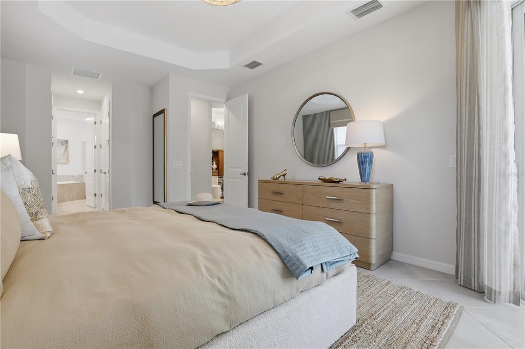 7153 Inlet Isles Lakewood Ranch, FL 34202 - Photo 19 of 26 a bedroom with a bed and a mirror