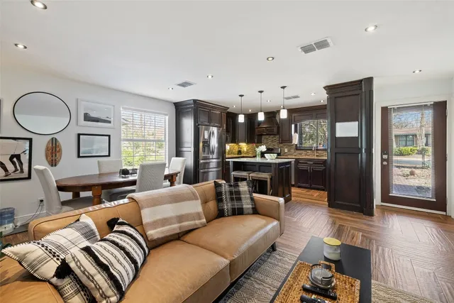 a living room with furniture and kitchen view