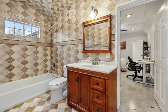 a bathroom with a sink toilet a mirror and shower