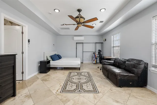 a living room with furniture and a ceiling fan