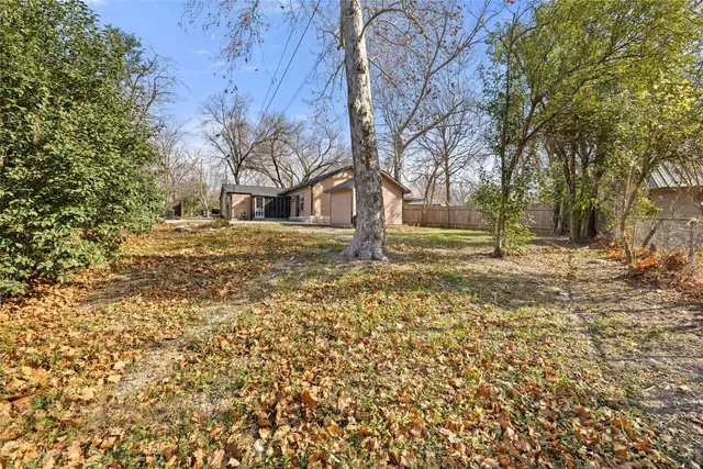 a front view of a house with a yard covered in snow