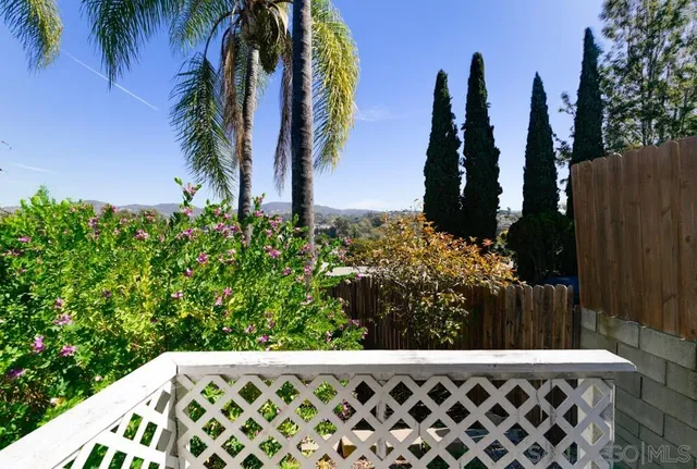 a view of a yard with wooden fence