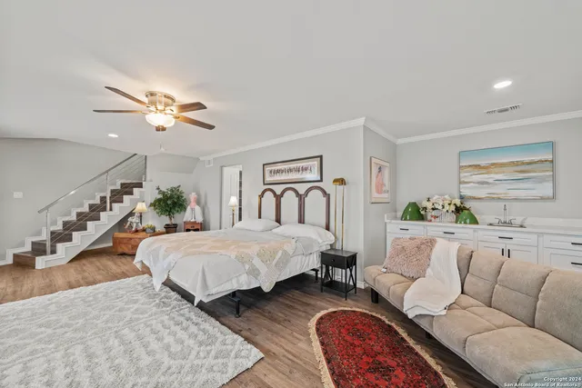 a spacious bedroom with a large bed couch and a window