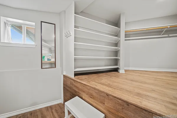 a room with a wooden floor and a window