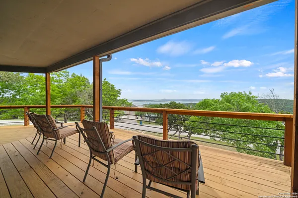 a view of a balcony with lake view and wooden floor