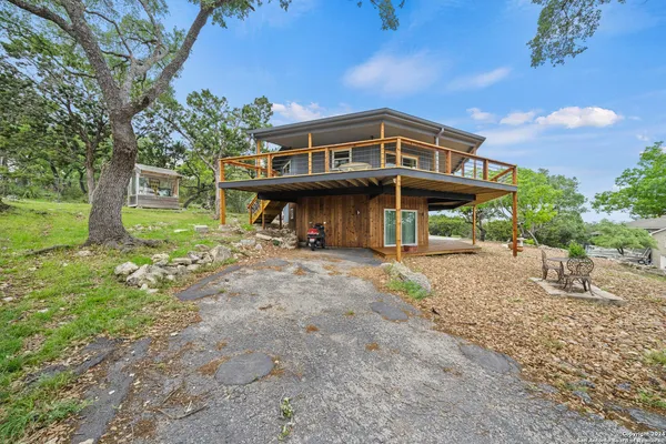 a view of a house with backyard porch and sitting area