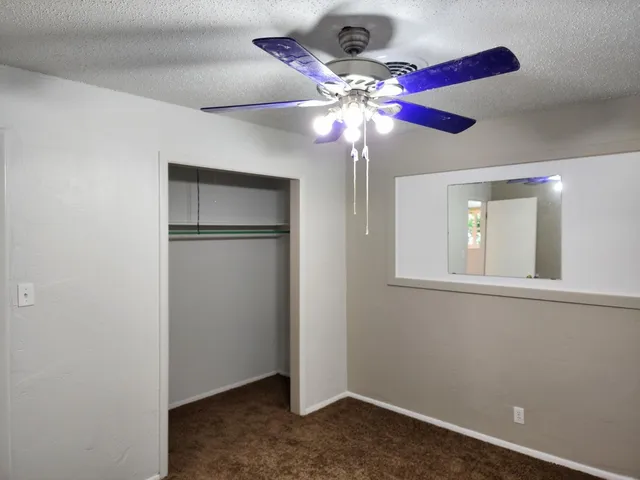 a view of a livingroom with a ceiling fan and a fan
