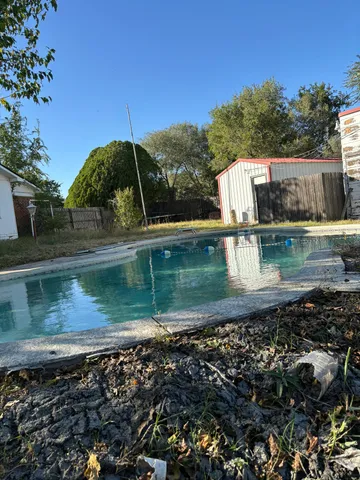 a view of a water pond with green yard