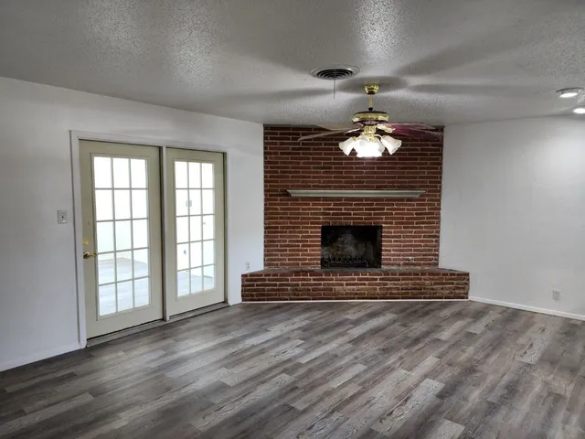 wooden floor in an empty room with a fireplace