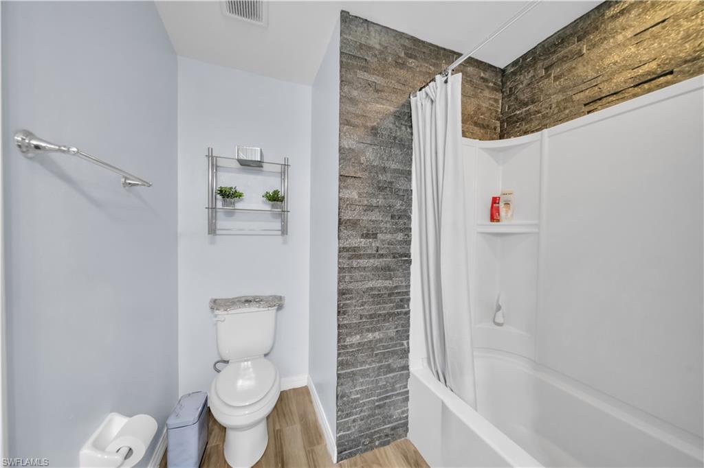 175 Shadowview Court Lehigh Acres, FL 33974 - Photo 29 of 39 Bathroom featuring light wood-style floors and shower / tub combo