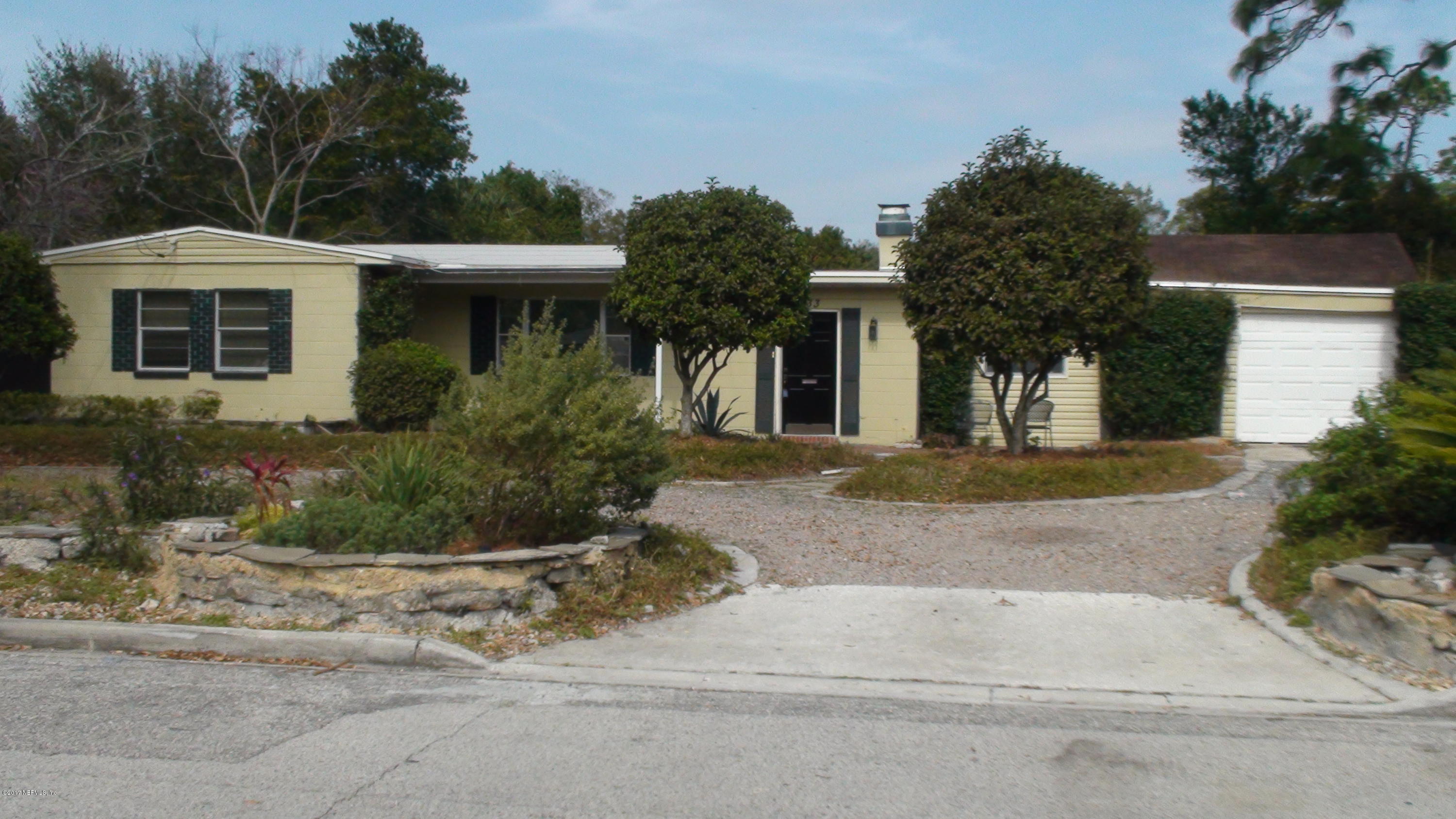 a view of a house with a yard and plants