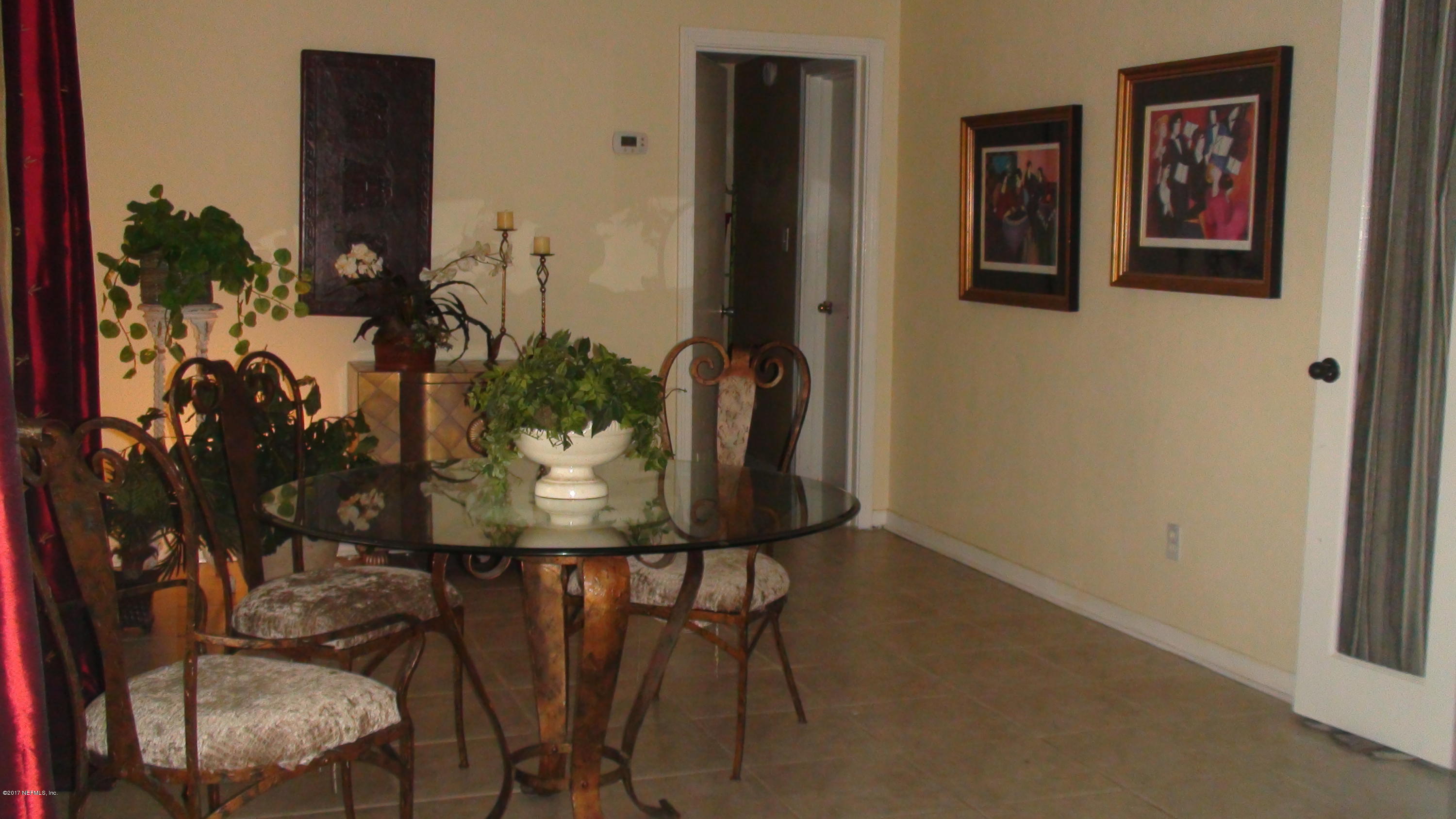 2733 Rainbow Road Jacksonville, FL 32217 - Photo 5 of 16 a view of a balcony with chair and potted plant