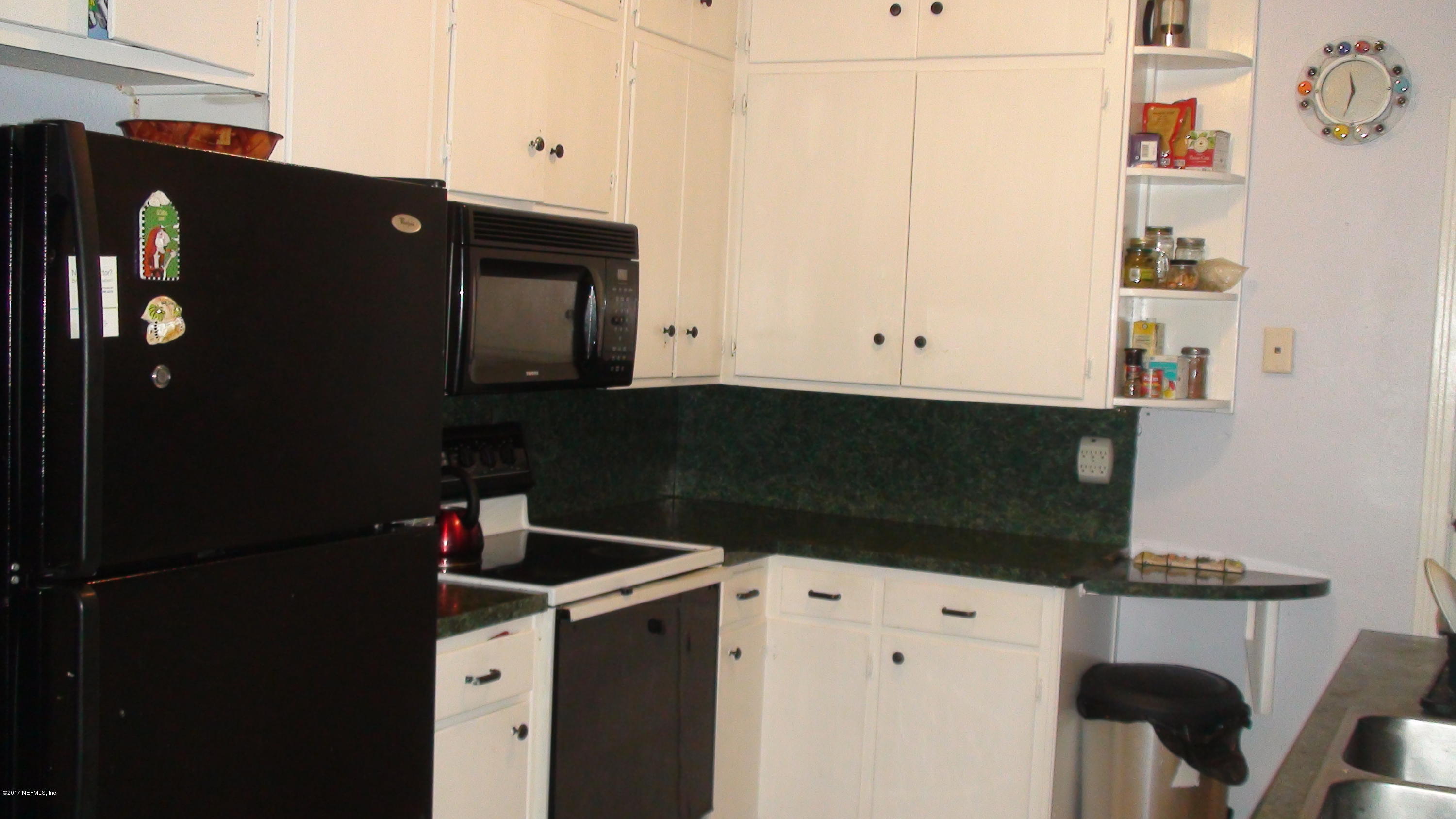 2733 Rainbow Road Jacksonville, FL 32217 - Photo 7 of 16 a kitchen with a refrigerator and cabinets