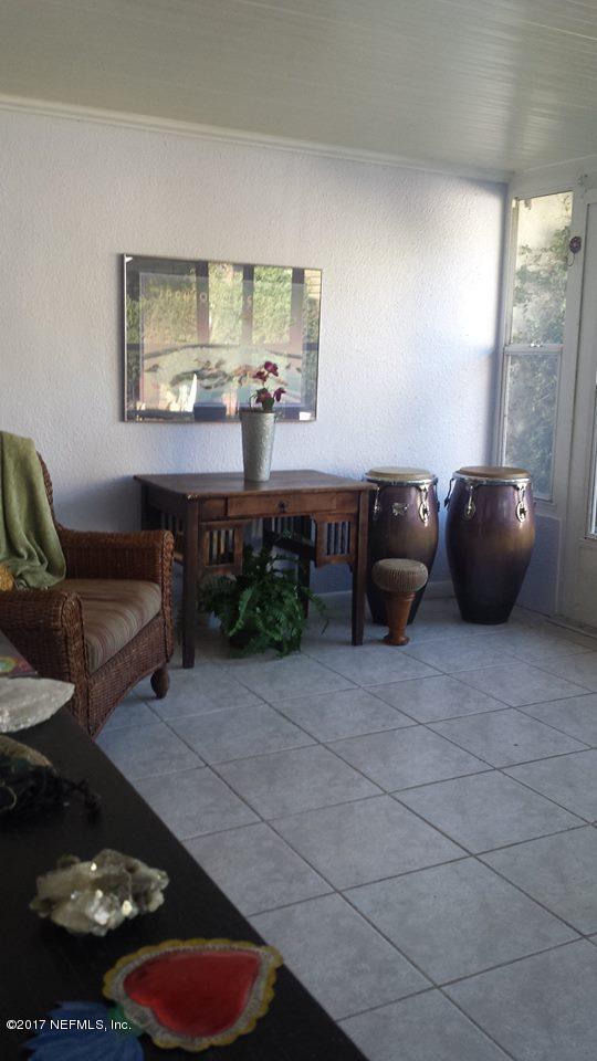2733 Rainbow Road Jacksonville, FL 32217 - Photo 9 of 16 a living room with furniture and a floor to ceiling window