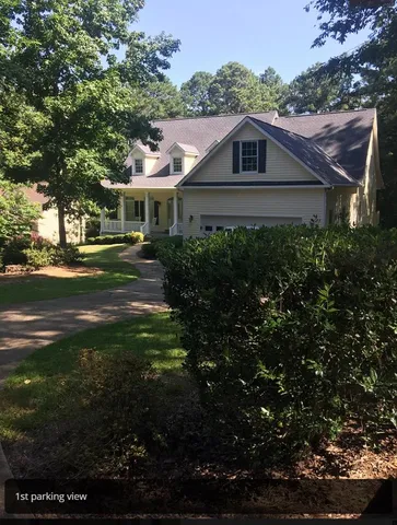 a front view of house with yard and green space