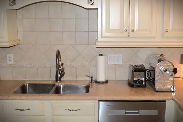 a kitchen with white cabinets and a sink