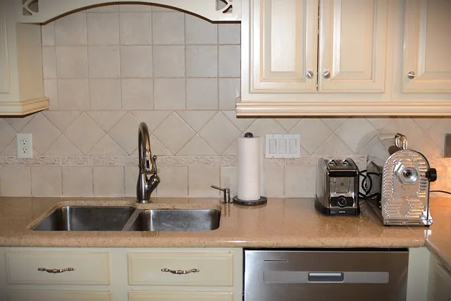 a kitchen with white cabinets and a sink