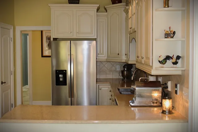 a kitchen with stainless steel appliances granite countertop a refrigerator and a stove
