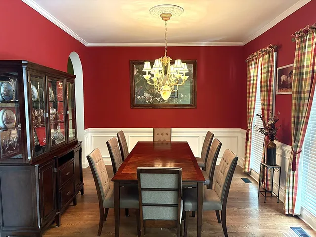 a view of a dining room with furniture wooden floor and window