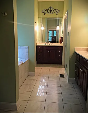 a bathroom with a sink a mirror and a shower