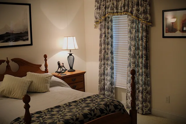 a bedroom with a bed and a window