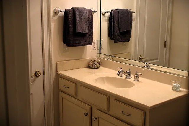 a bathroom with a sink vanity and a mirror