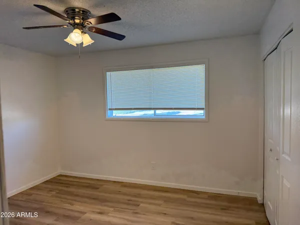 a view of an empty room with wooden floor