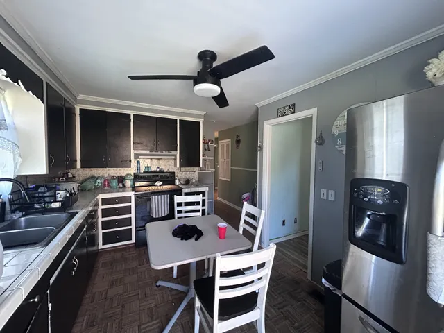 a kitchen with a dining table and chairs