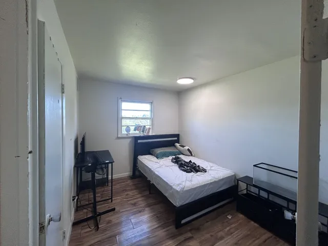 a bedroom with bed and a window