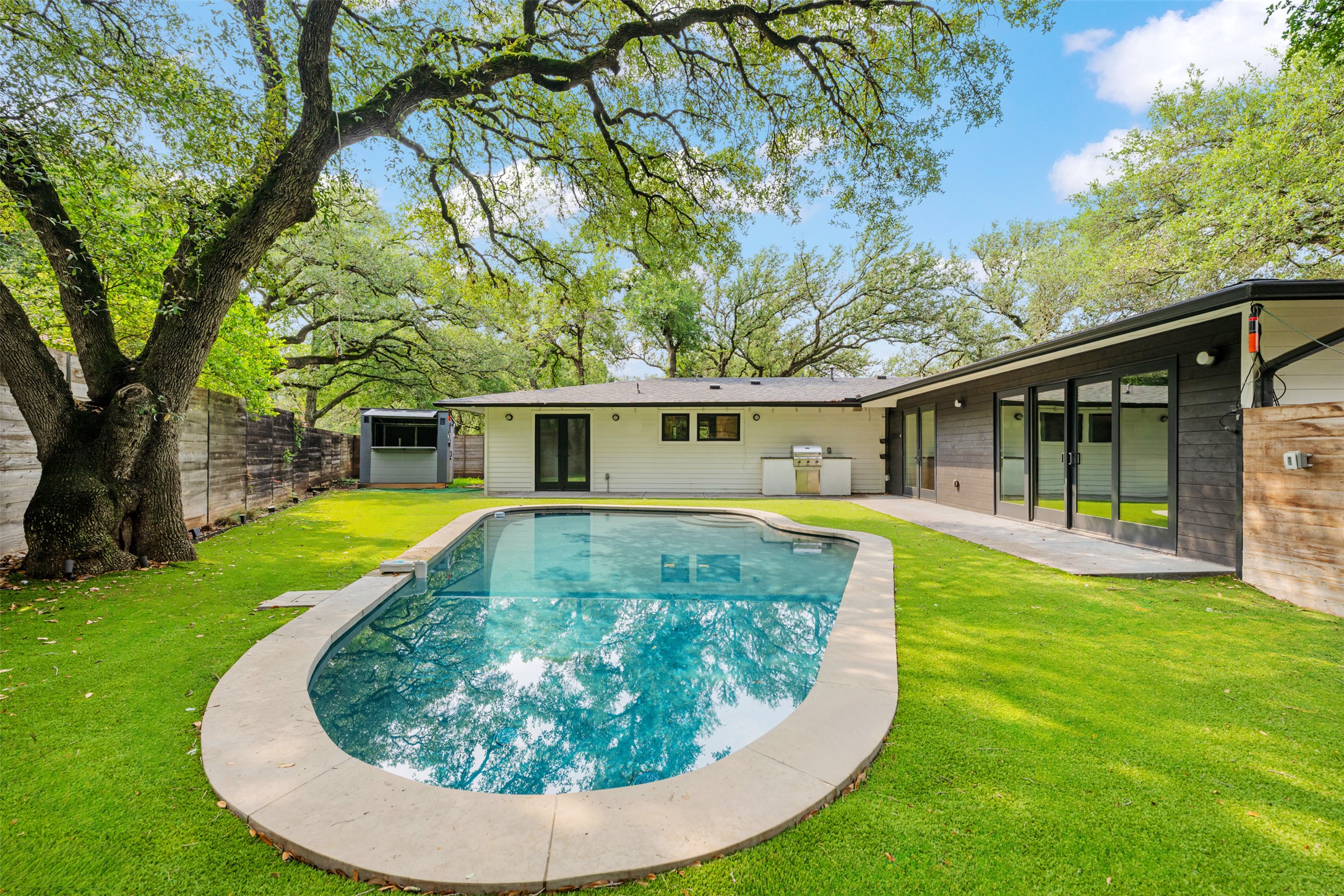 8900 Point W Drive Austin, TX 78759 - Photo 38 of 40 An inviting backyard oasis awaits with a sparkling pool and mature shade trees.