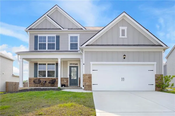 a front view of a house with a yard