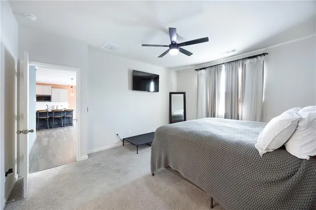 a bedroom with a large bed and a chandelier