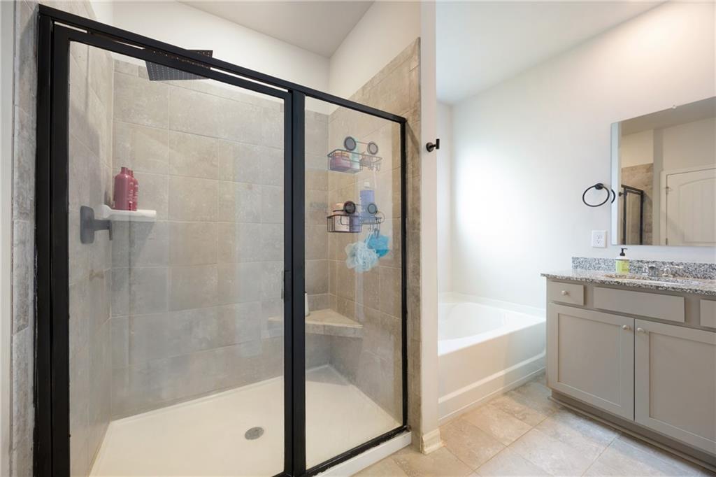 7571 Deerridge Way Fairburn, GA 30213 - Photo 14 of 26 a bathroom with a shower and a bath tub