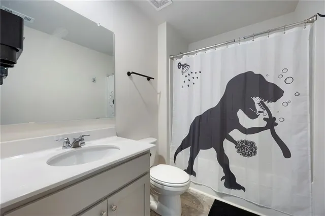 a bathroom with a sink toilet and a mirror