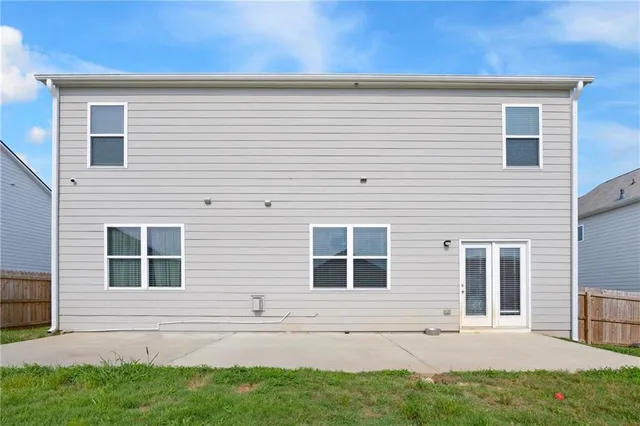 a view of house with backyard