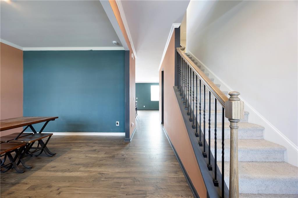 7571 Deerridge Way Fairburn, GA 30213 - Photo 4 of 26 a view of a hallway with wooden floor and stairs