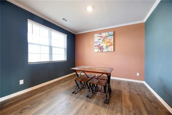 a workspace with wooden floor and a window
