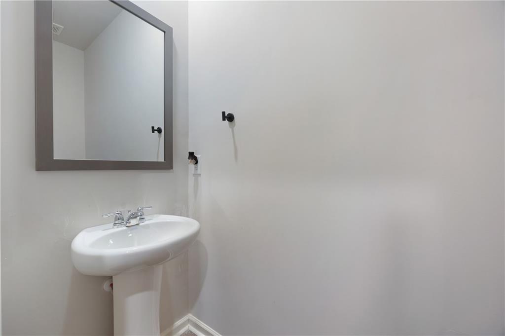 7571 Deerridge Way Fairburn, GA 30213 - Photo 6 of 26 a bathroom with a sink and a mirror