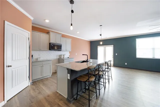 a kitchen with a table chairs refrigerator and microwave