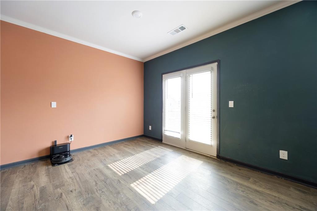 7571 Deerridge Way Fairburn, GA 30213 - Photo 9 of 26 a view of an empty room with wooden floor and a window